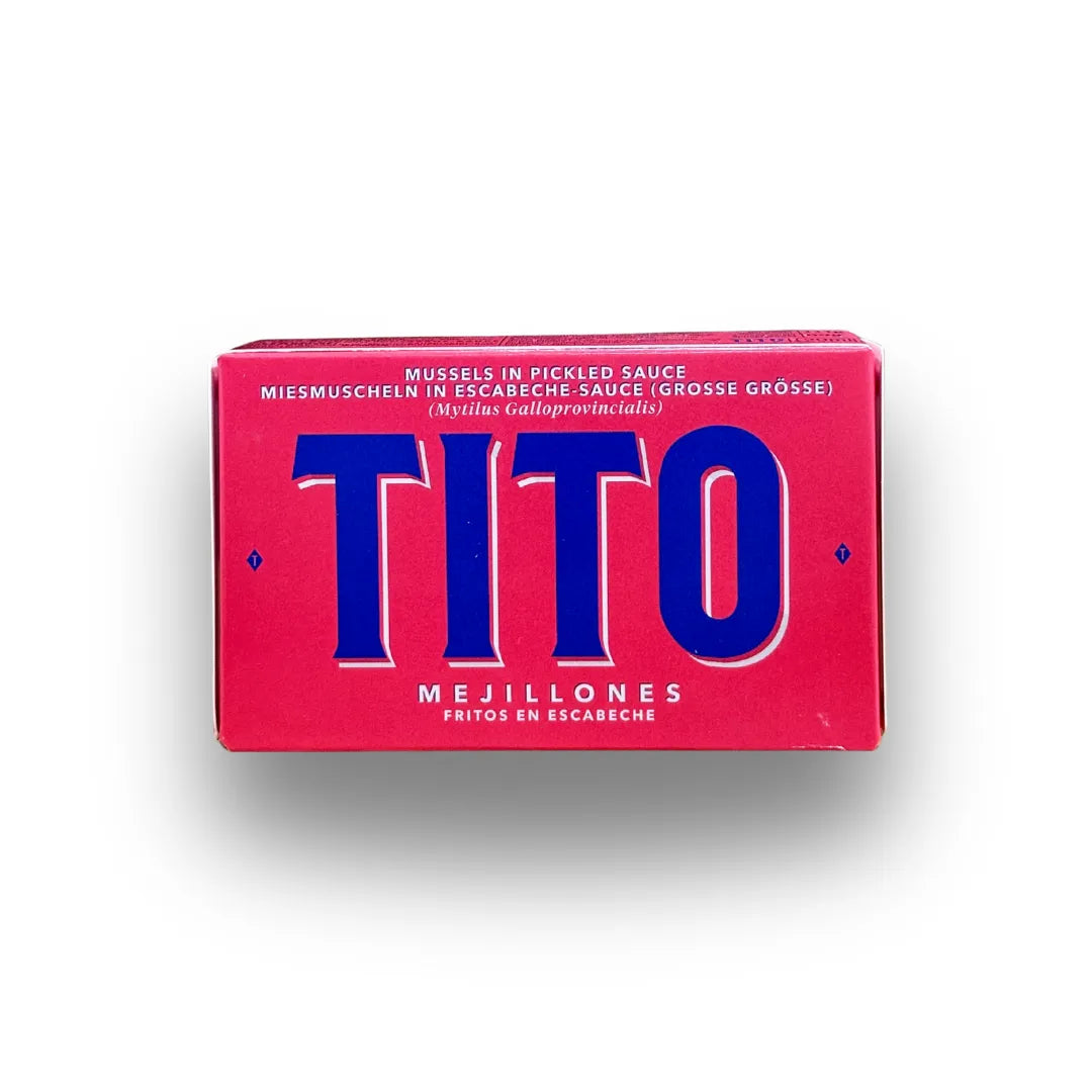 Estuche de mejillones en escabeche de Conservas TiTo sobre fondo blanco de estudio, en vibrante tono rojo con el nombre de la marca TITO en letras mayúsculas de gran tamaño en azul oscuro en D'12 Gourmet
