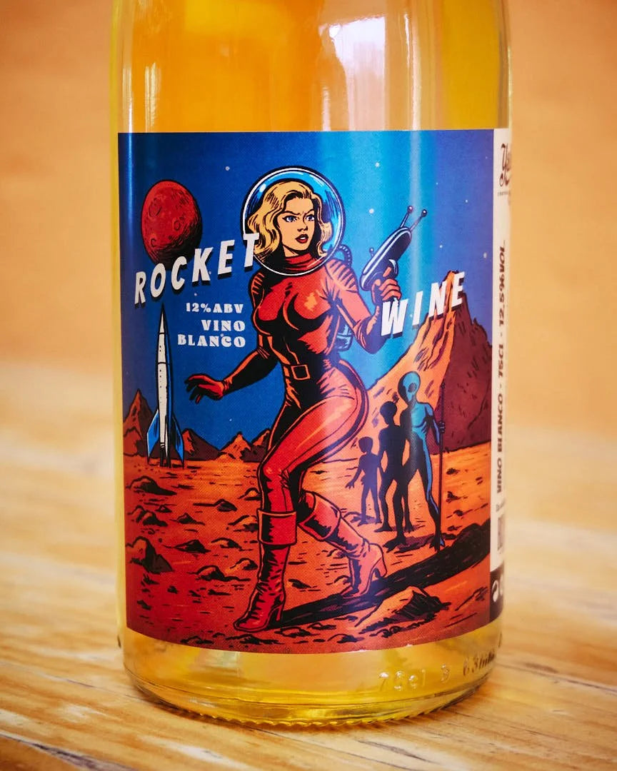 Detalle en plano corto de la etiqueta de la botella de vino Rocket Wine de Bodegas Yakka, mostrando en detalle la ilustración retro-futurista estilo ciencia ficción ochentera ambientada en Marte en D'12 Gourmet