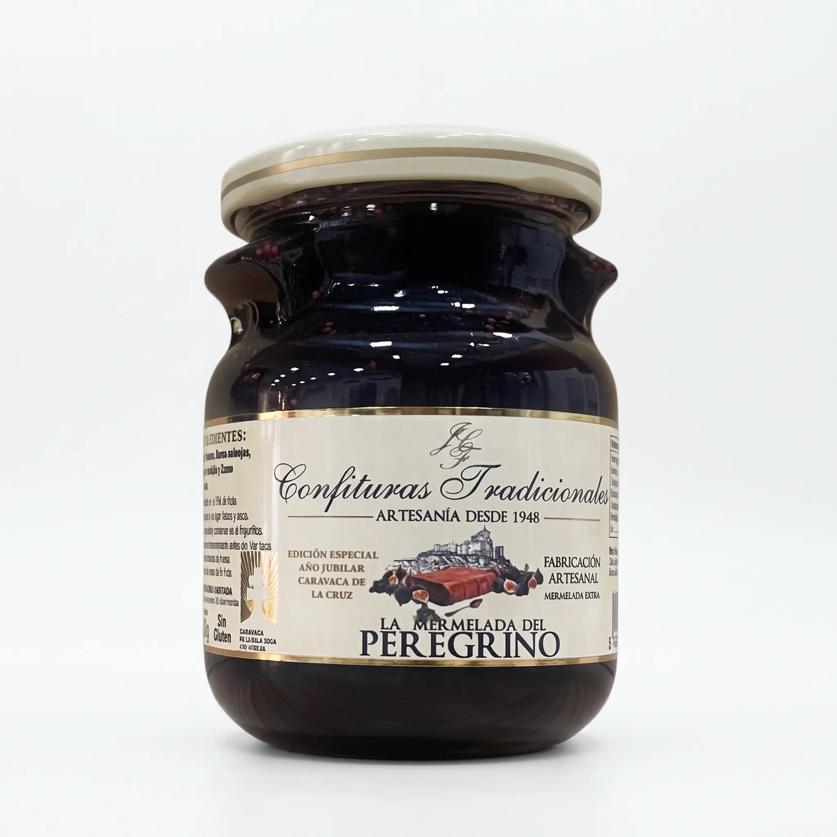 Frasco transparente de confitura La Mermelada del Peregrino con etiqueta blanca, dejando ver la mermelada de higos y moras y mostrando la ilustración de las frutas junto a la marca.