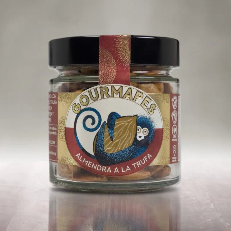 Tarro de almendra a la trufa tostada a mano de Gourmapes, de diseño moderno y colores rojos y dorados con el mono en el centro sujetando una almendra.