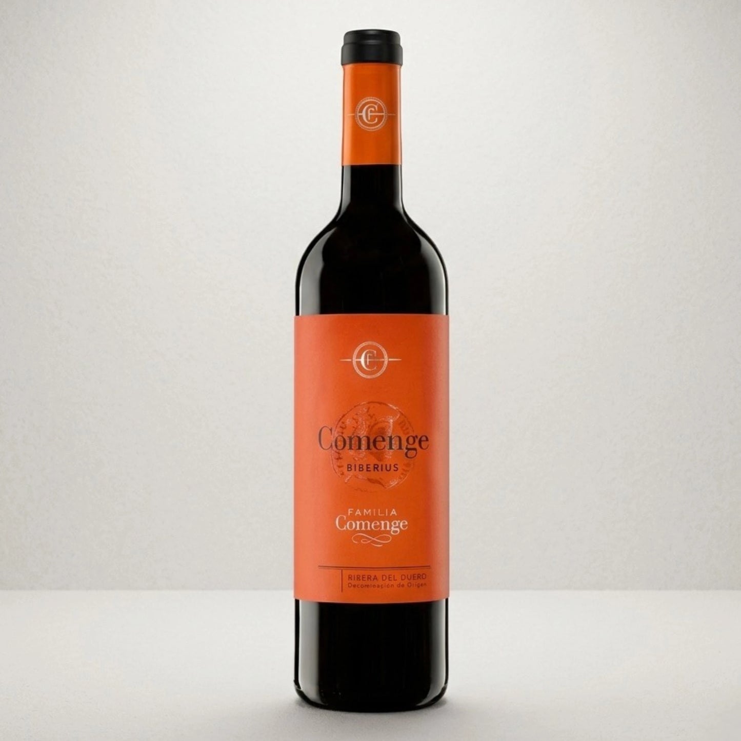 Botella de vino tinto Comenge Biberius con denominación de origen Ribera del duero 100% Tempranillo. De color naranja la etiqueta y el tapón con letras negras y doradas.
